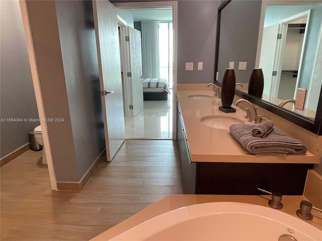 bathroom featuring wood-type flooring, vanity, and toilet