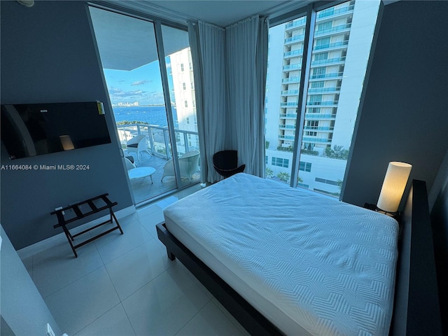 bedroom with tile patterned floors and access to outside