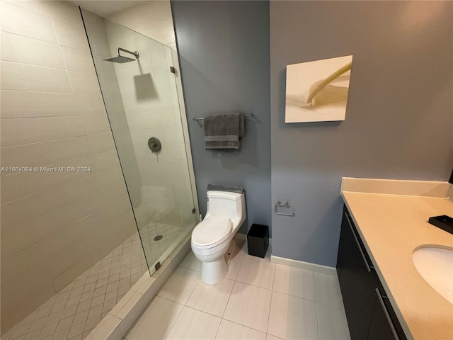 bathroom with tiled shower, vanity, toilet, and tile patterned flooring