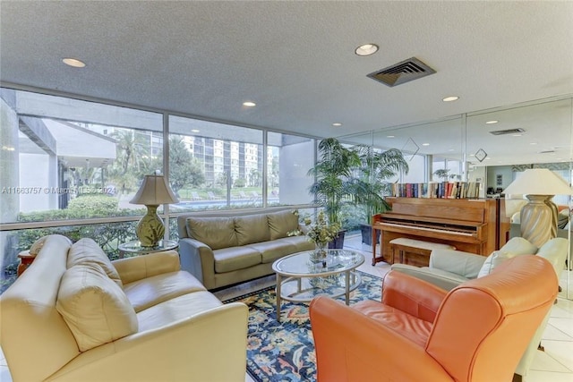 tiled living room featuring expansive windows and a textured ceiling