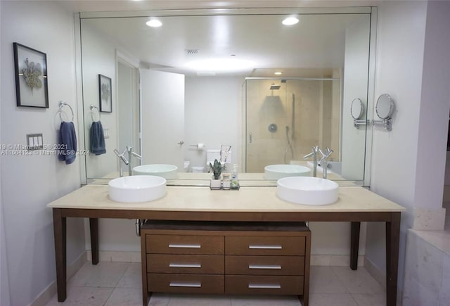 bathroom featuring vanity, a shower with shower door, and tile patterned floors