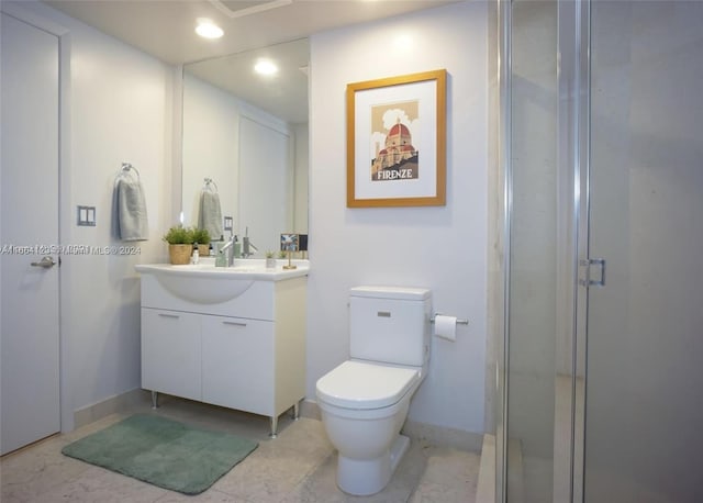 bathroom with walk in shower, vanity, toilet, and tile patterned floors