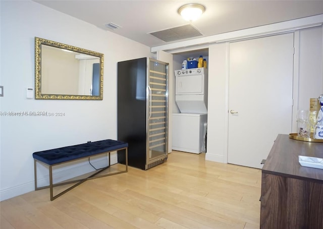 interior space featuring light wood-type flooring and stacked washer / drying machine