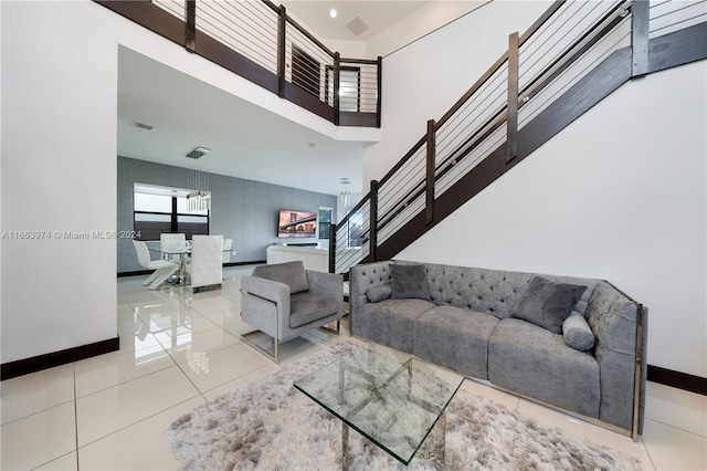 living room featuring a high ceiling and light tile patterned floors