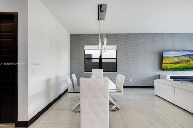 tiled dining area with a chandelier