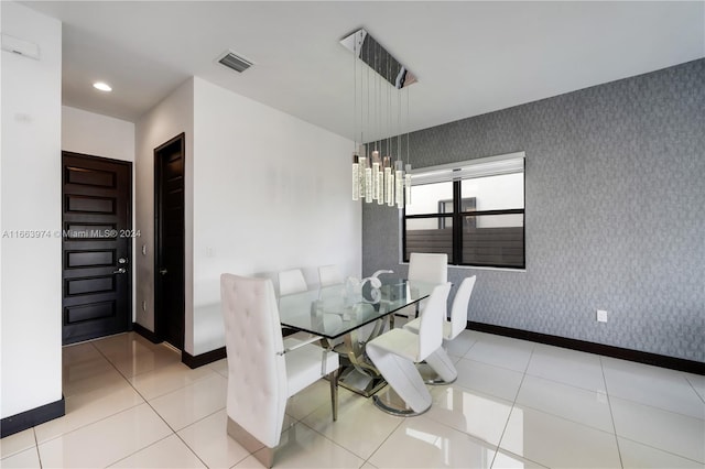 unfurnished dining area featuring a chandelier and light tile patterned floors