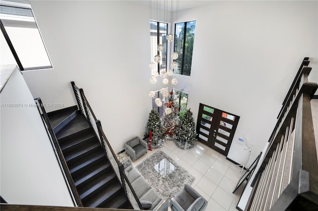 living room featuring a towering ceiling and light tile patterned flooring