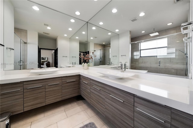 bathroom featuring vanity, tile patterned flooring, and an enclosed shower