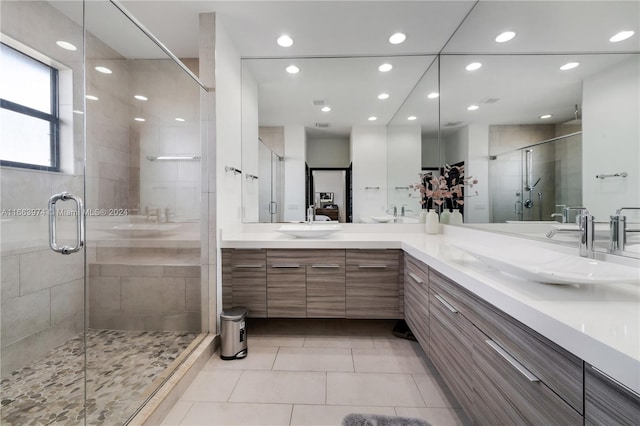 bathroom with tile patterned flooring, vanity, and a shower with door