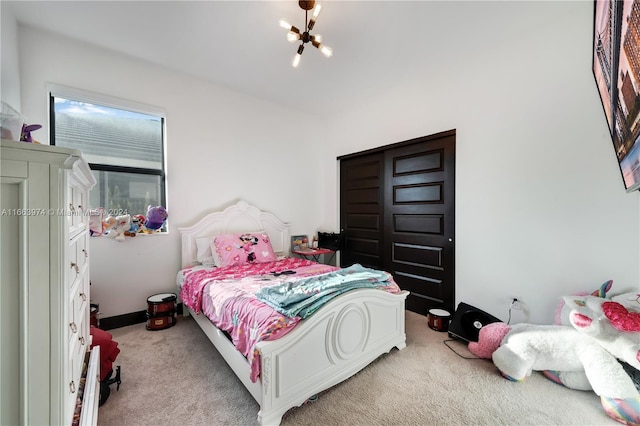 carpeted bedroom featuring a notable chandelier