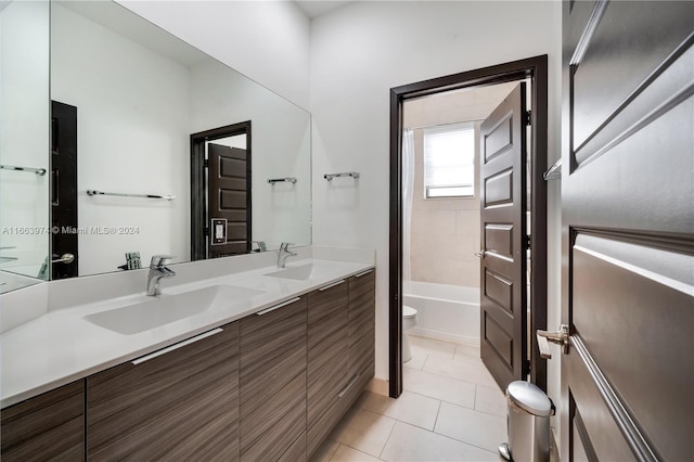 full bathroom with tiled shower / bath combo, tile patterned flooring, vanity, and toilet