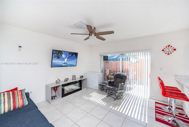 tiled living room featuring ceiling fan