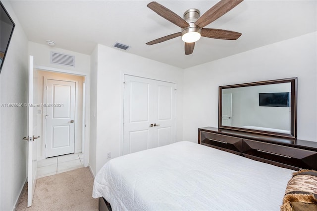 carpeted bedroom with a closet and ceiling fan