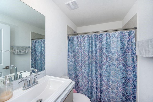 bathroom featuring vanity, toilet, and a shower with shower curtain