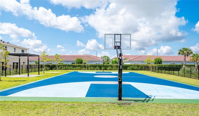 view of basketball court with a lawn