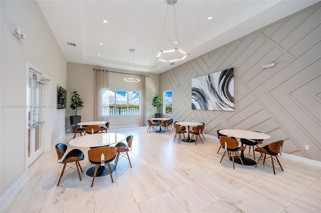 dining space with a tray ceiling