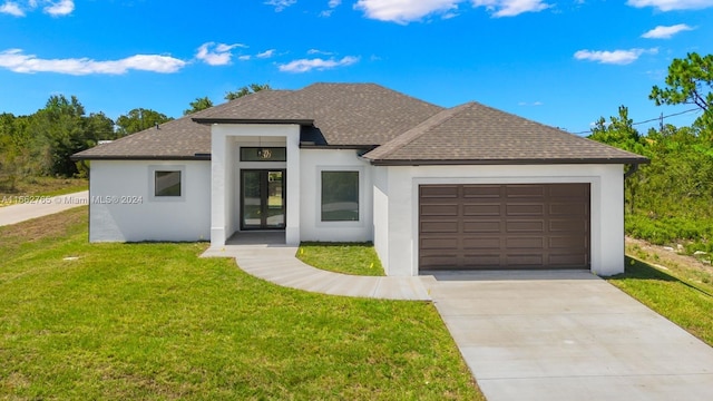 view of front of house with a garage and a front lawn