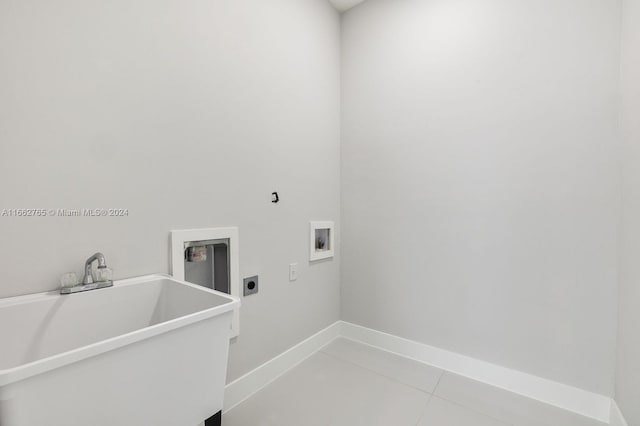 washroom featuring tile patterned flooring, washer hookup, sink, and hookup for an electric dryer