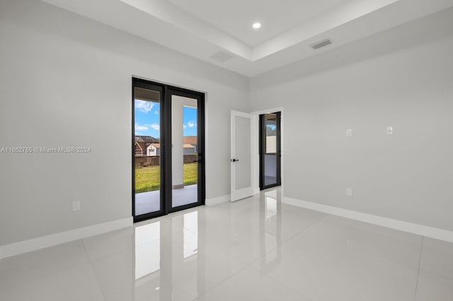 tiled spare room with french doors