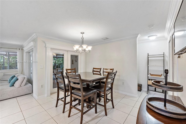 dining space with a notable chandelier, baseboards, crown molding, and light tile patterned flooring