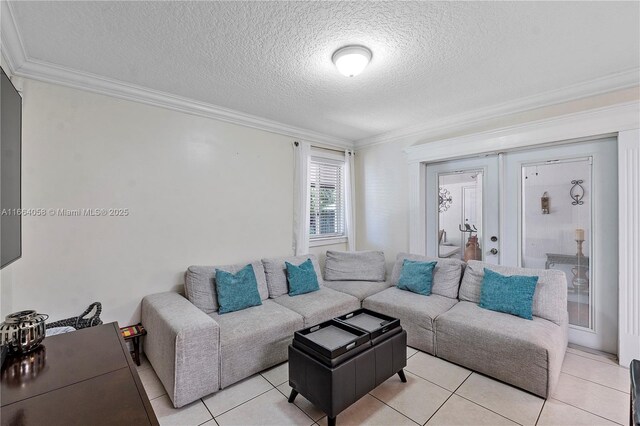 living room featuring light tile patterned floors, a textured ceiling, french doors, and crown molding