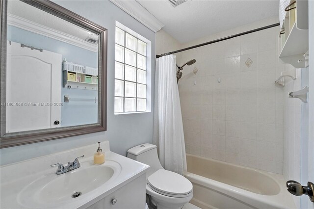 full bathroom with shower / tub combo with curtain, vanity, a textured ceiling, and toilet