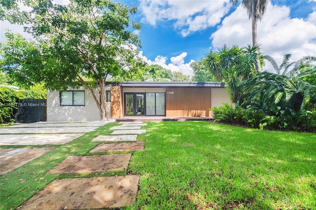 view of front of home featuring a patio, a front lawn, and french doors