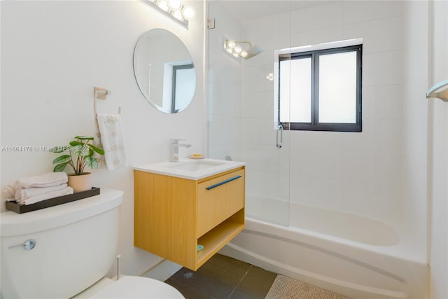 full bathroom featuring tile patterned flooring, tiled shower / bath combo, vanity, and toilet