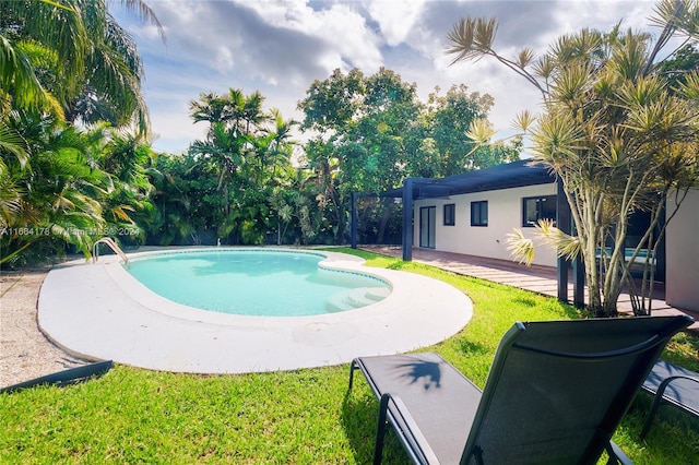 view of pool featuring a lawn and a patio