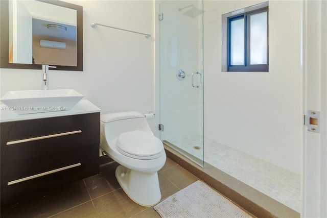 bathroom featuring tile patterned floors, an enclosed shower, vanity, and toilet