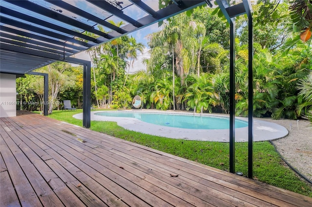 view of pool featuring a lawn, a pergola, and a deck