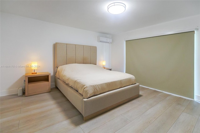 1955 Alamanda Dr, North Miami, FL 33181 - bedroom featuring a wall mounted air conditioner and light wood-type flooring