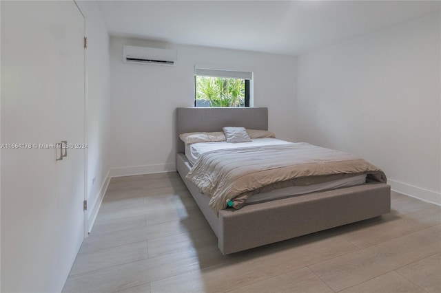 1955 Alamanda Dr, North Miami, FL 33181 - bedroom featuring a wall mounted AC and light wood-type flooring