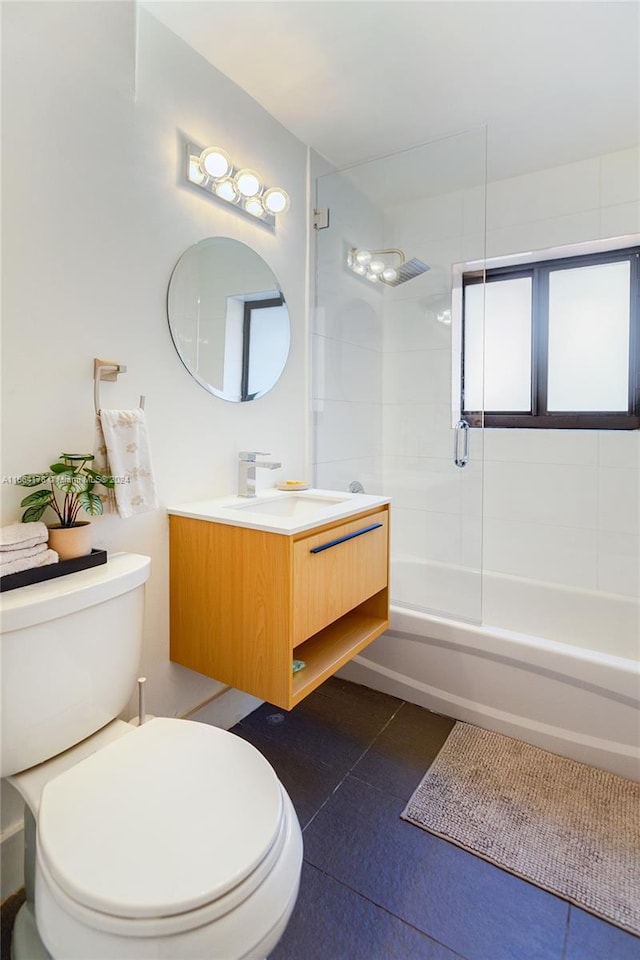 full bathroom featuring enclosed tub / shower combo, vanity, toilet, and tile patterned floors