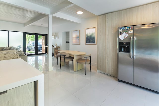 kitchen featuring light brown cabinetry, light tile patterned flooring, beam ceiling, and stainless steel fridge with ice dispenser