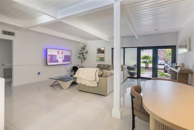 tiled living room featuring french doors and beamed ceiling