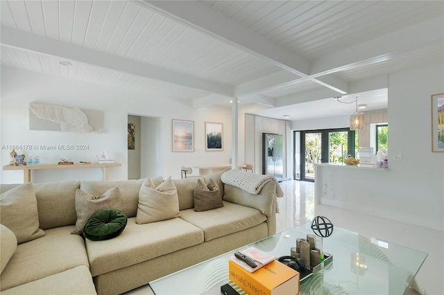 living room featuring beamed ceiling and french doors