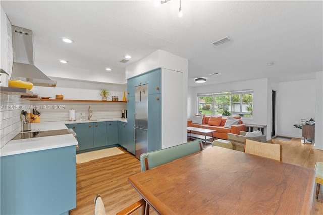 dining space featuring light wood-type flooring and sink