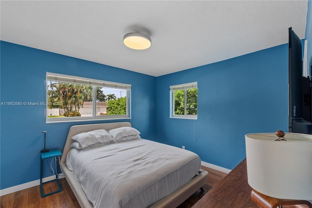 bedroom featuring dark wood-type flooring