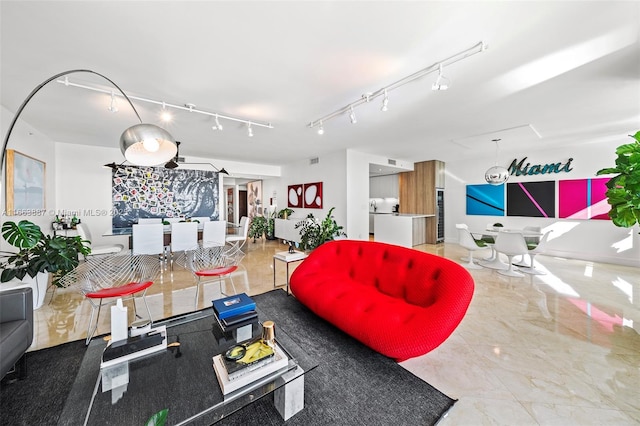 living room featuring marble finish floor, visible vents, and track lighting