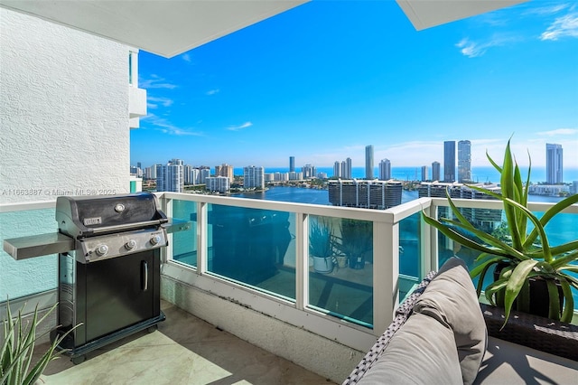 balcony featuring a view of city, a water view, and a grill