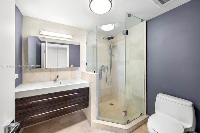 full bathroom with a stall shower, tile patterned flooring, vanity, and toilet