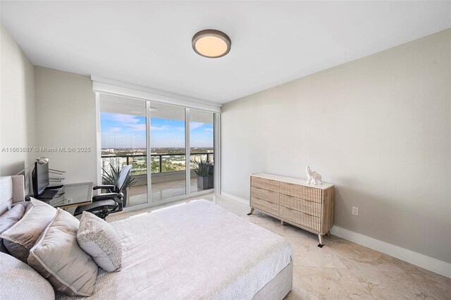 bedroom featuring baseboards, access to outside, and floor to ceiling windows