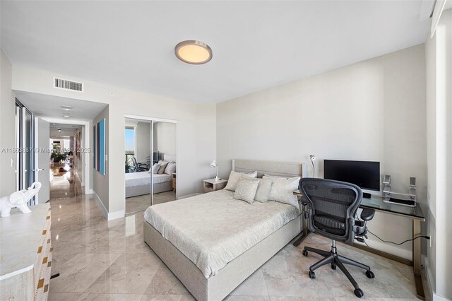 bedroom featuring marble finish floor, french doors, a closet, and visible vents