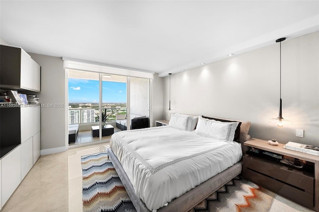 bedroom featuring access to exterior, floor to ceiling windows, and baseboards