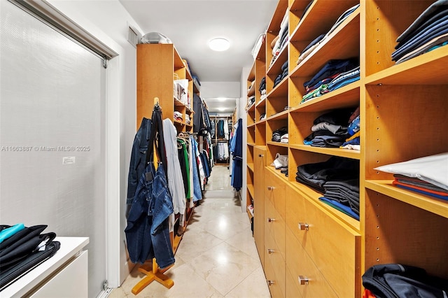 walk in closet with light tile patterned floors and visible vents