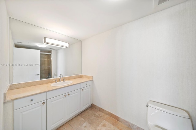 full bathroom with vanity, toilet, and walk in shower