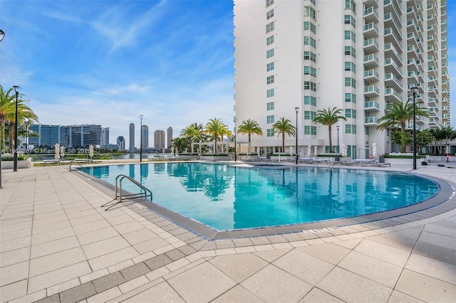 pool featuring a patio area and a city view