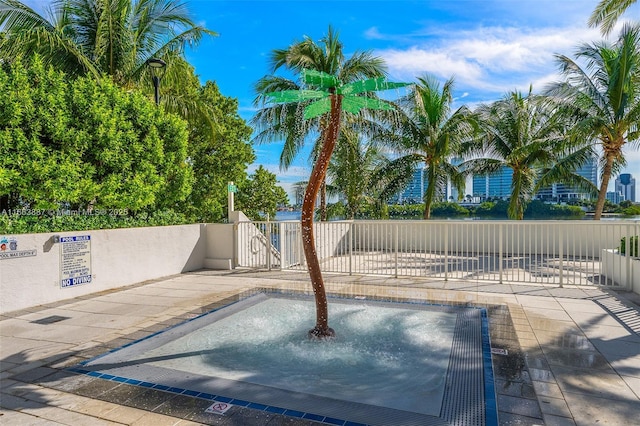 view of swimming pool featuring a gate and fence