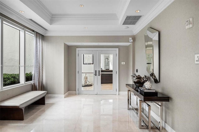 entrance foyer with baseboards, visible vents, a raised ceiling, ornamental molding, and french doors